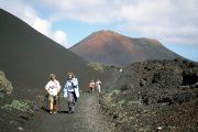 Walkers follow a short nature trail through part of the Timanfaya National Park.